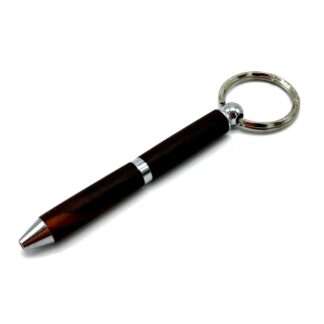 Close-up of a dark fountain pen with silver tips and rings, nib at the tip visible on the left edge.